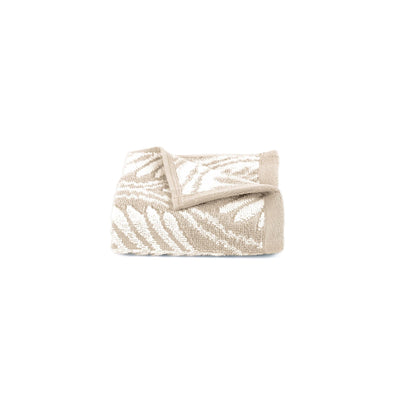 Sand washcloth with white pattern on a white background