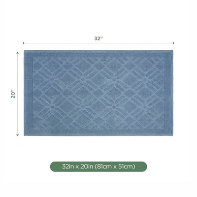 A rectangular blue bath rug with a raised diamond pattern, shown with dimension labels indicating 32 inches by 20 inches (81 cm x 51 cm) on a white background.