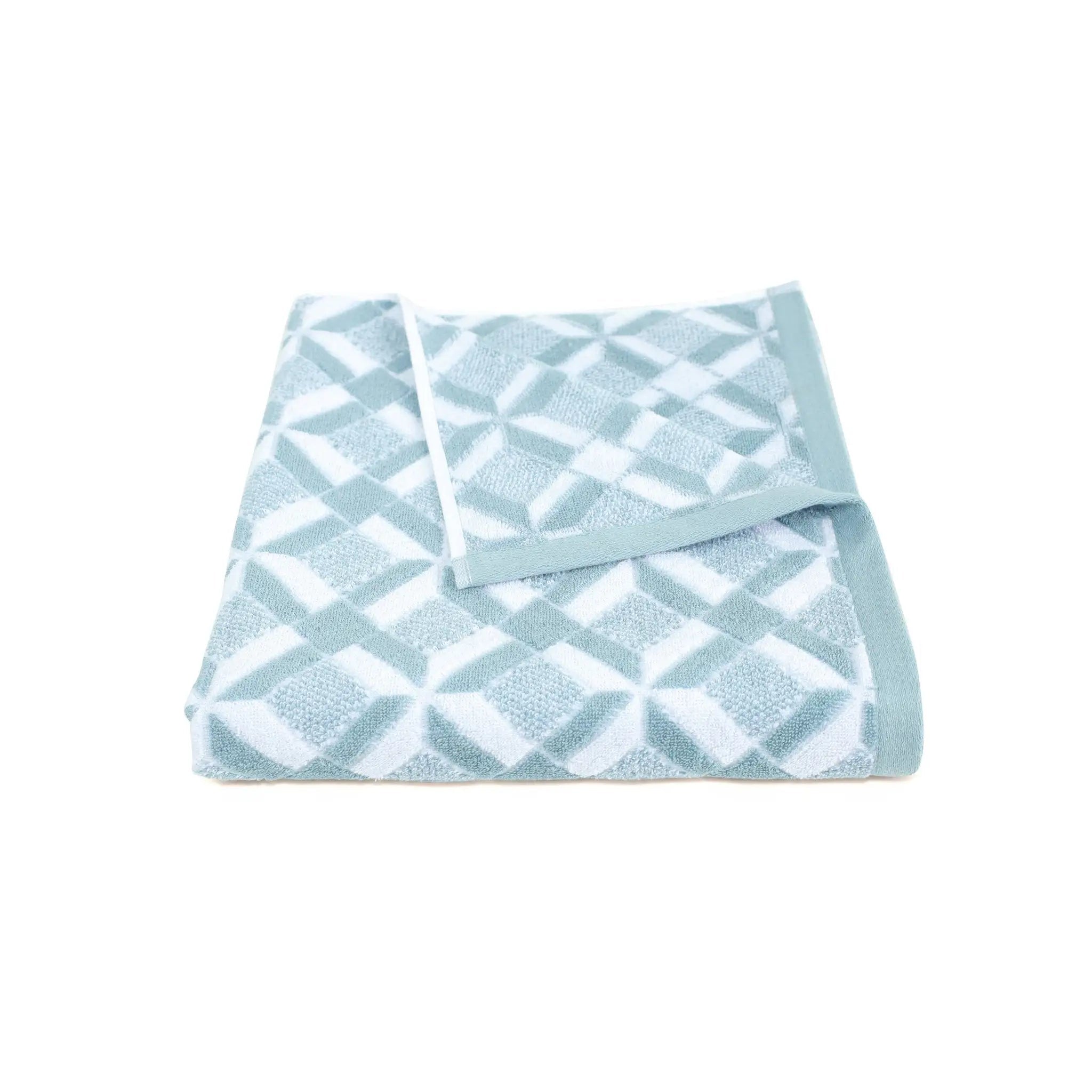 Folded mineral colored patterned bath towel on a white background
