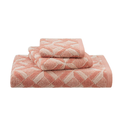 Set of clay-colored patterned towels on a white background