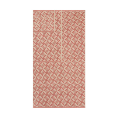  clay-colored patterned towels on a white background