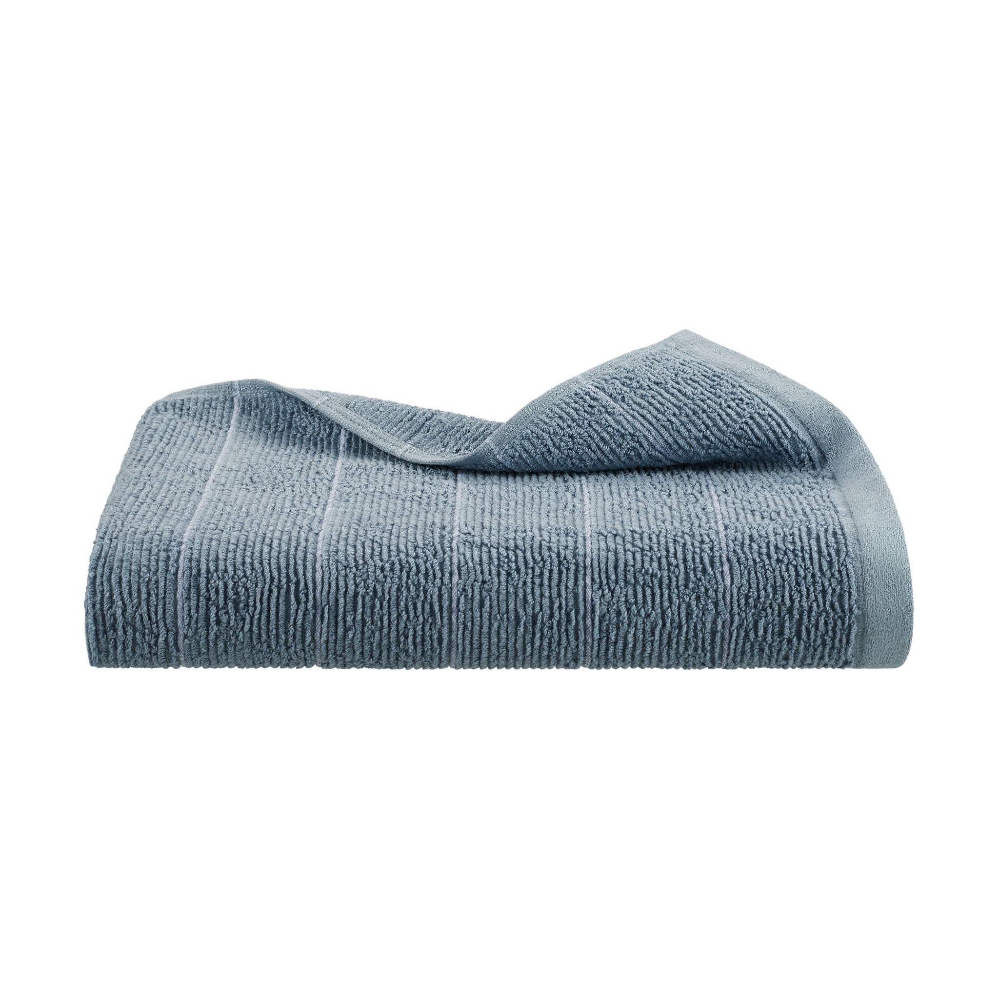Folded blue bath towel on a white background