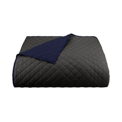 Graphite/navy reversible coverlet on a white background