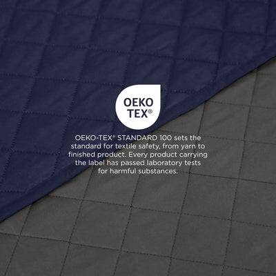 Close-up of a graphite/navy fabric with Oeko-Tex label on a dark background