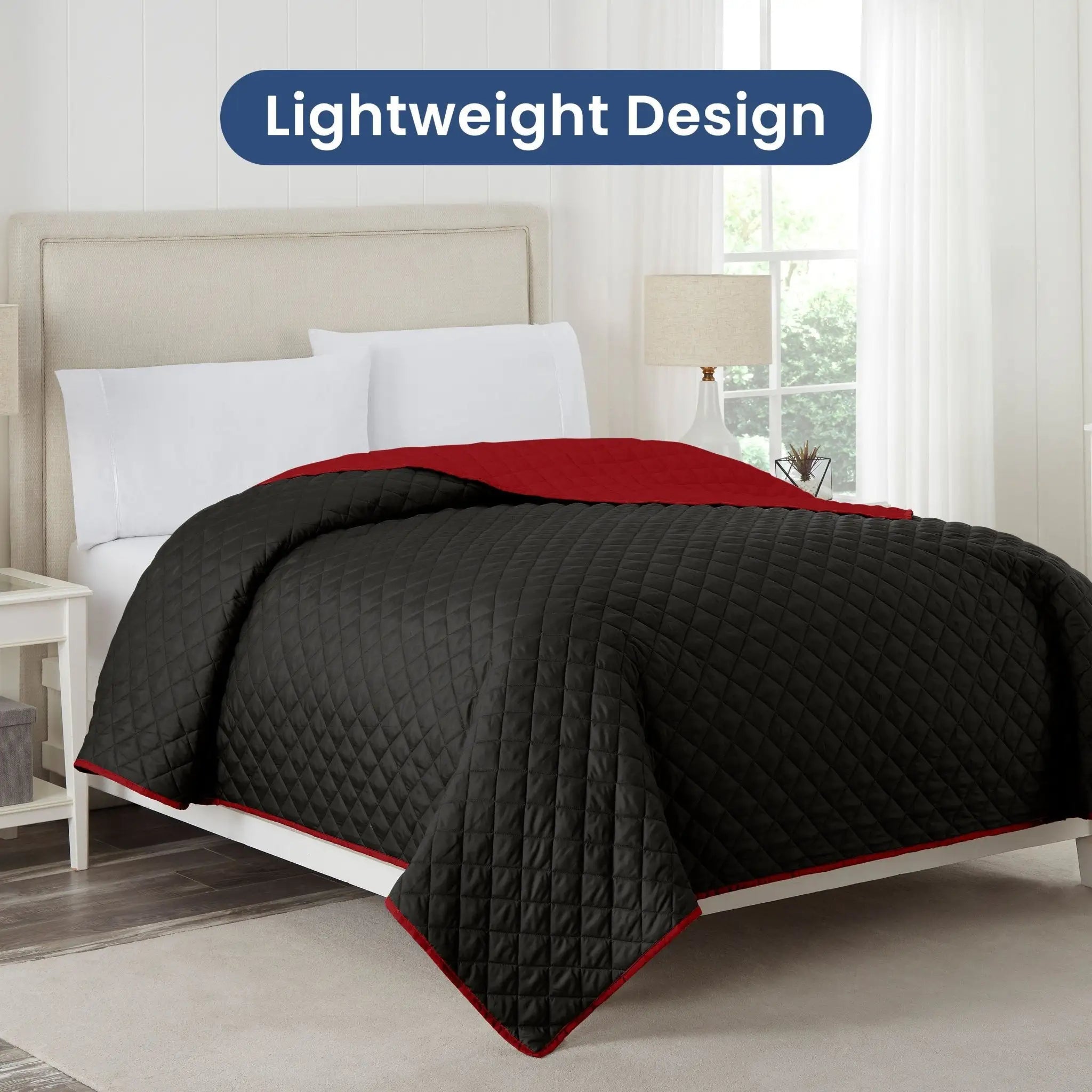 Ebony coverlet with red reverse on a bed in a bedroom setting, with 'Lightweight Design' text above.