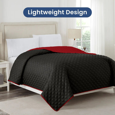 Ebony coverlet with red reverse on a bed in a bedroom setting, with 'Lightweight Design' text above.