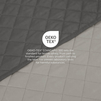 Light gray/graphite coverlet fabric with OEKO-TEX label on a gray background