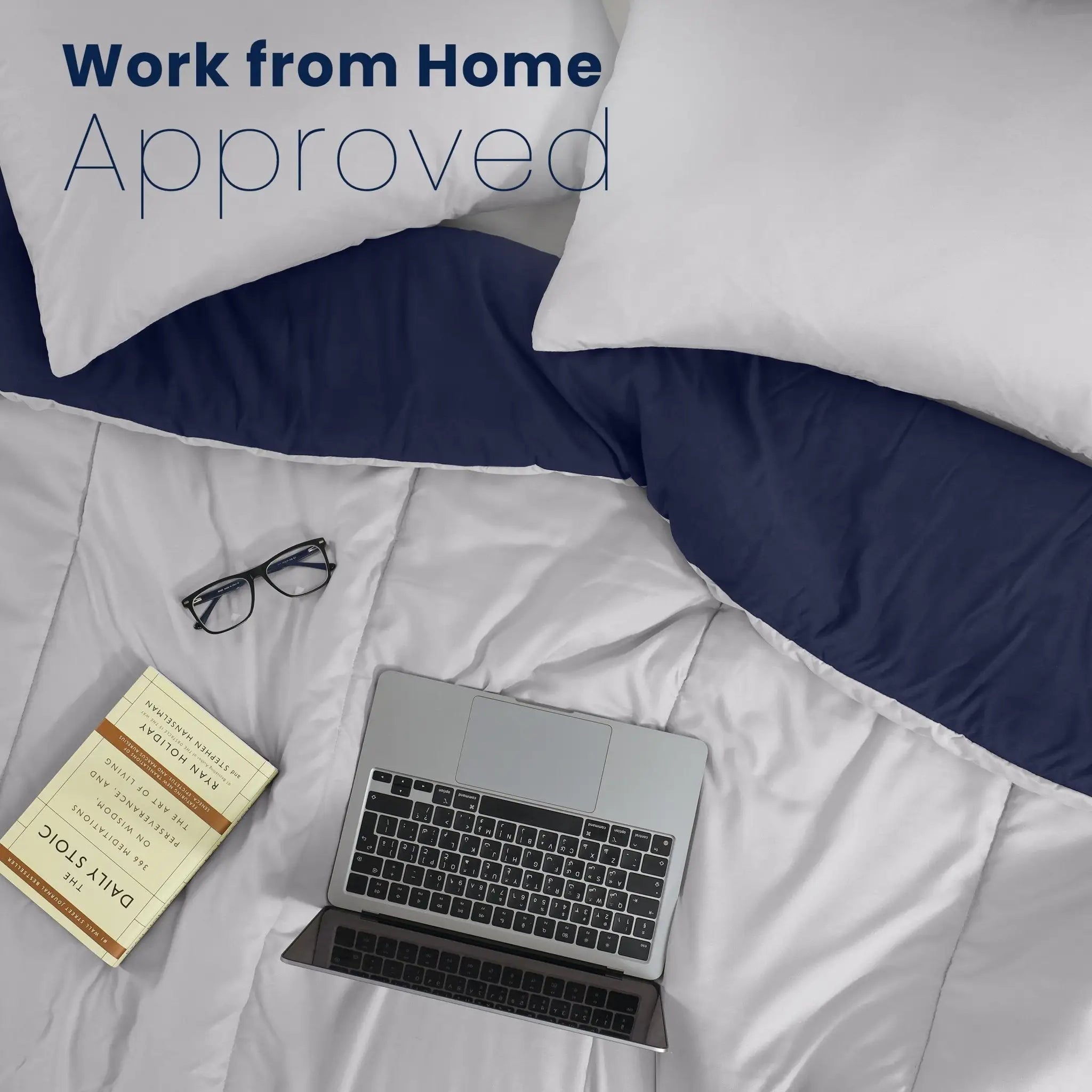 Light grey comforter with a navy reverse side with a closed laptop, eyeglasses, and a book. Large text at the top reads 'Work from Home Approved'.