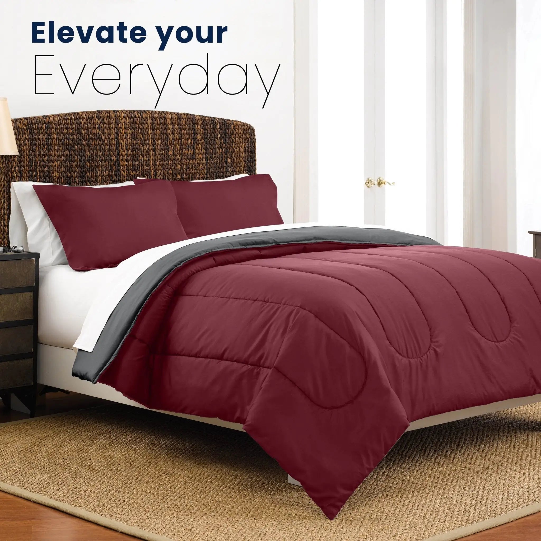 Bed with burgundy comforter and pillows in a bedroom setting, with text 'Elevate your Everyday'.