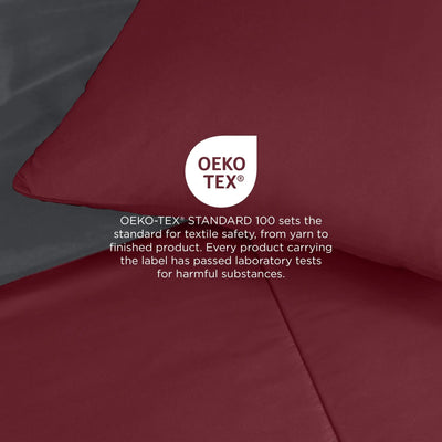 Burgundy comforter, with a white circular OEKO-TEX certification logo and explanatory text overlaid in the center.