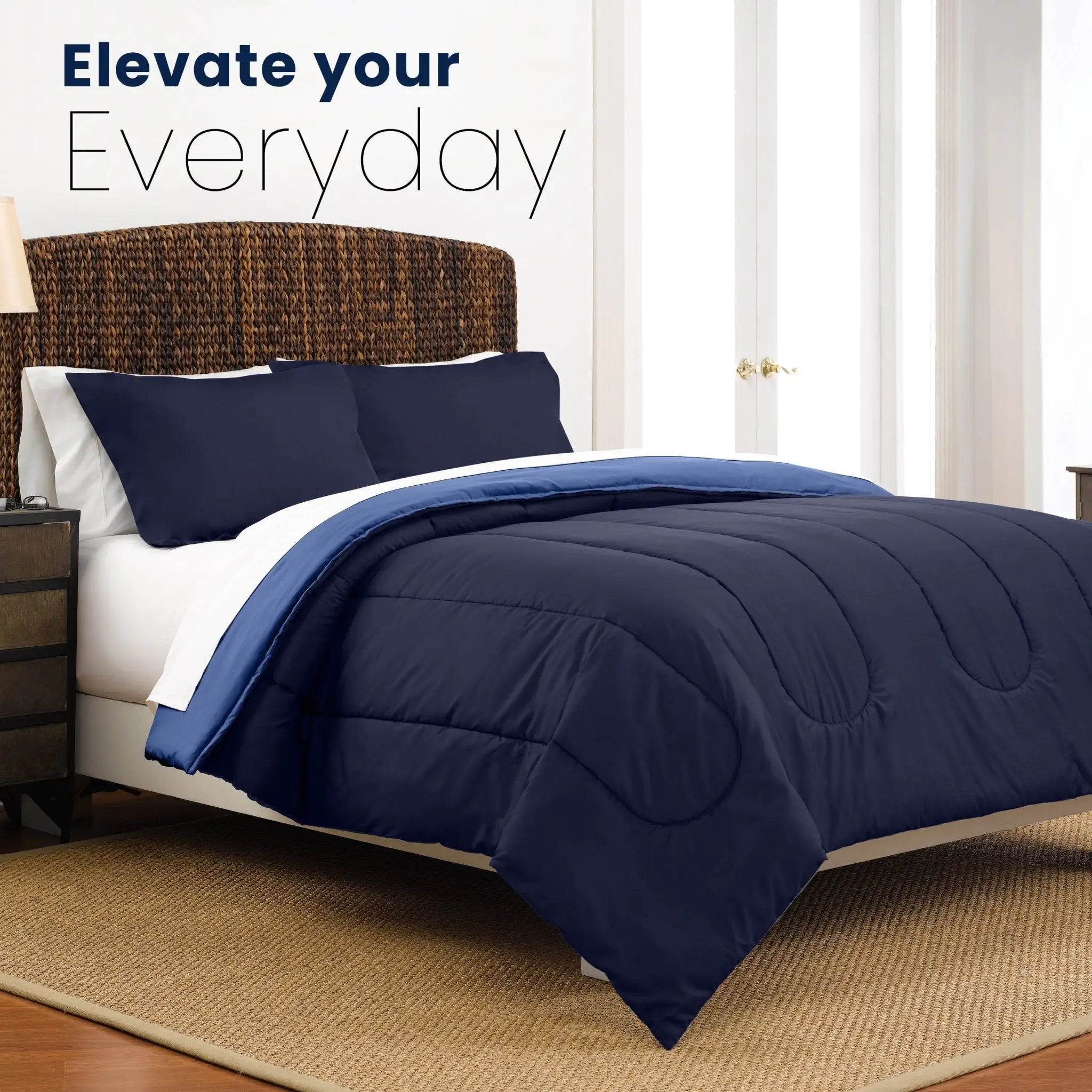Navy blue comforter on a bed with pillow shams in a bedroom setting, featuring text 'Elevate your Everyday'.
