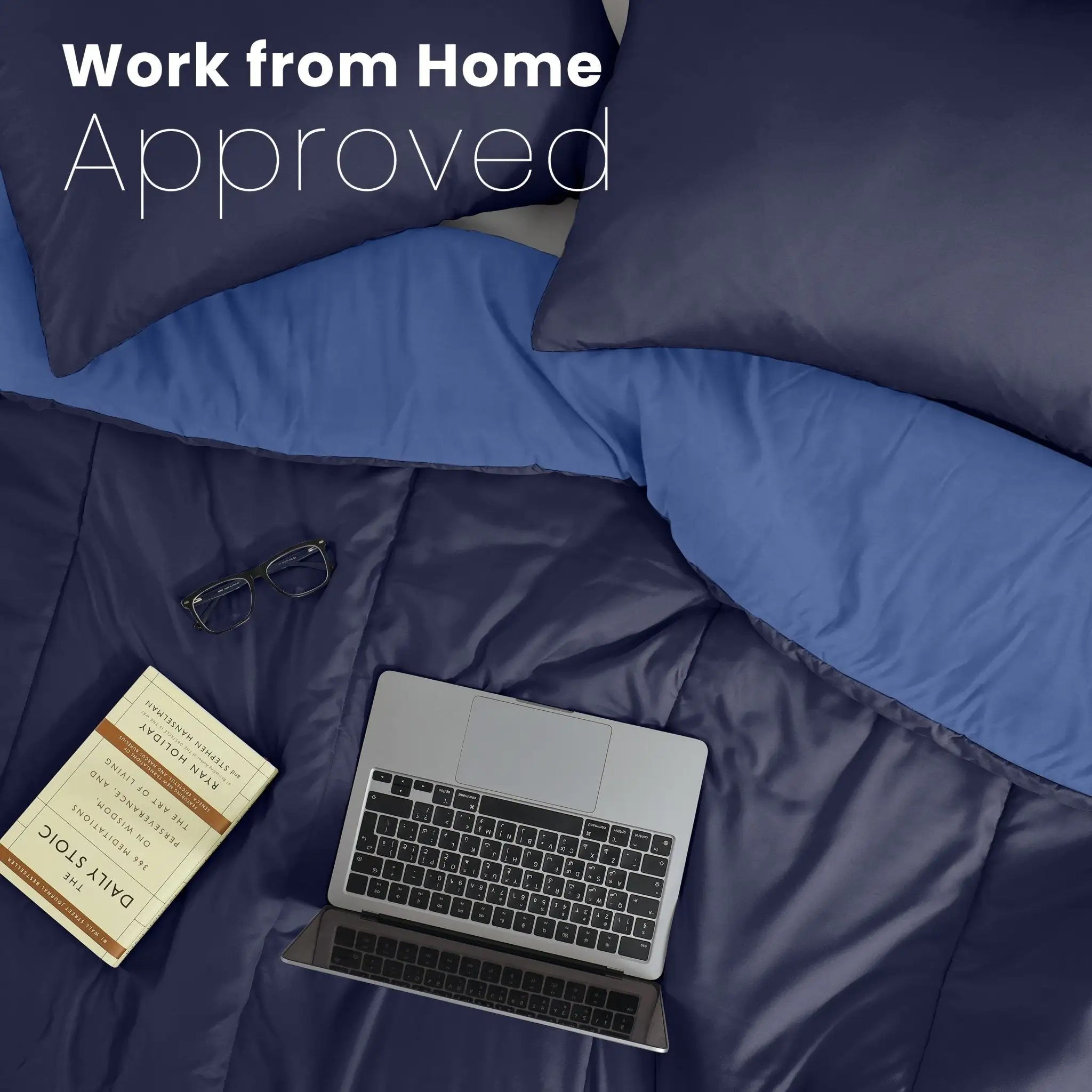 Navy comforter with a laptop, glasses, and notebook on top, labeled 'Work from Home Approved'.