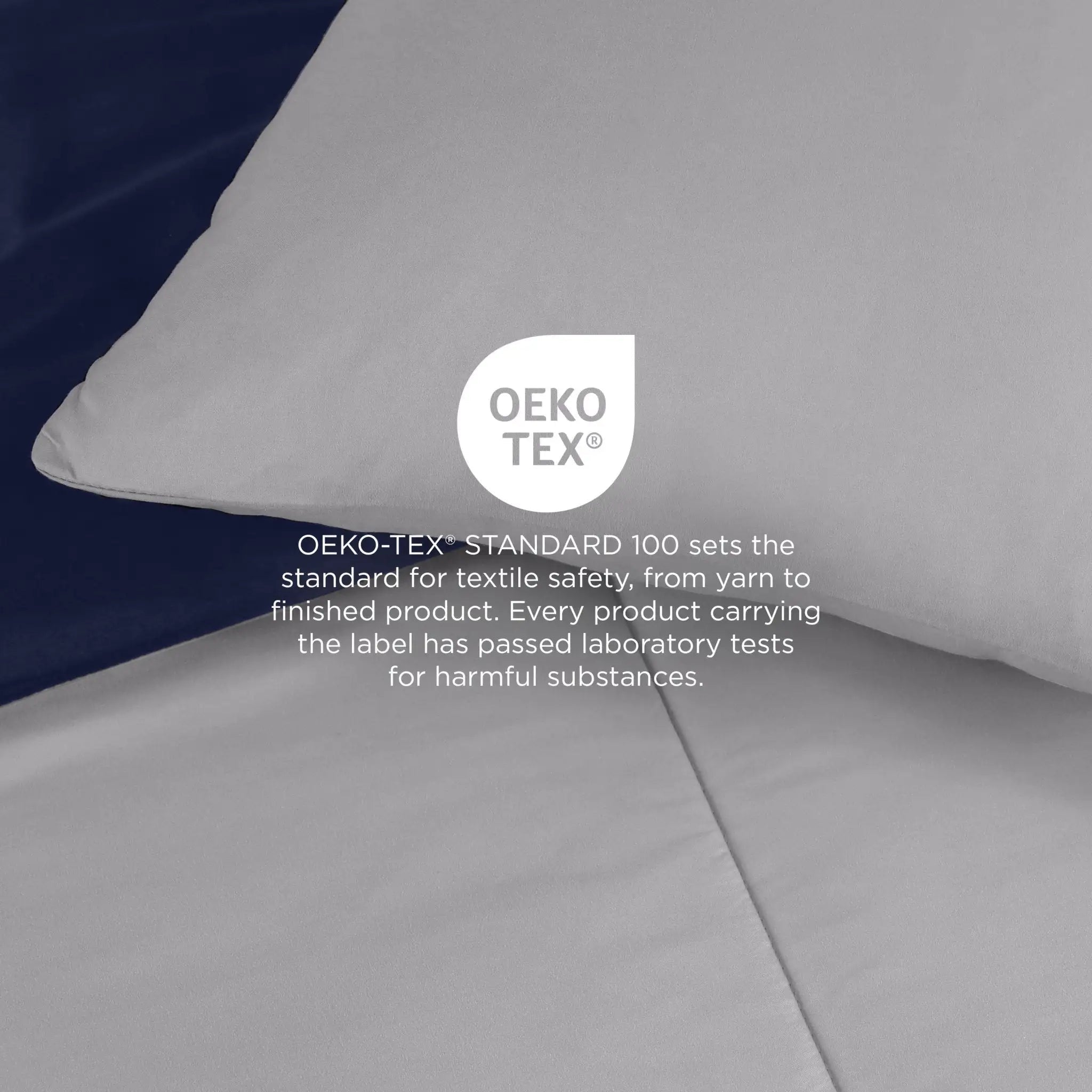 Light gray comforter set with OEKO-TEX certification label on a dark background