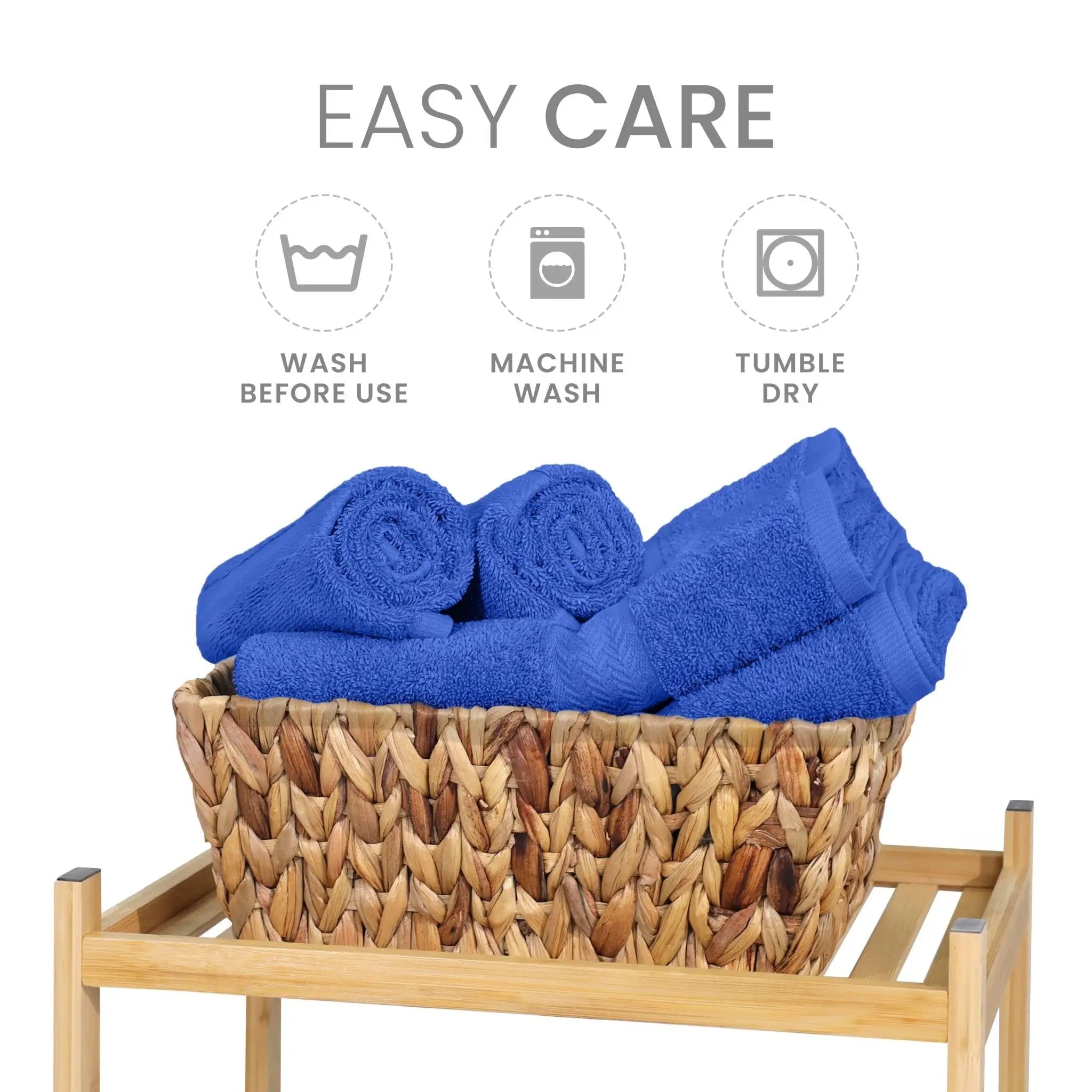 Cobalt blue towels in a woven basket with washing instructions on a white background