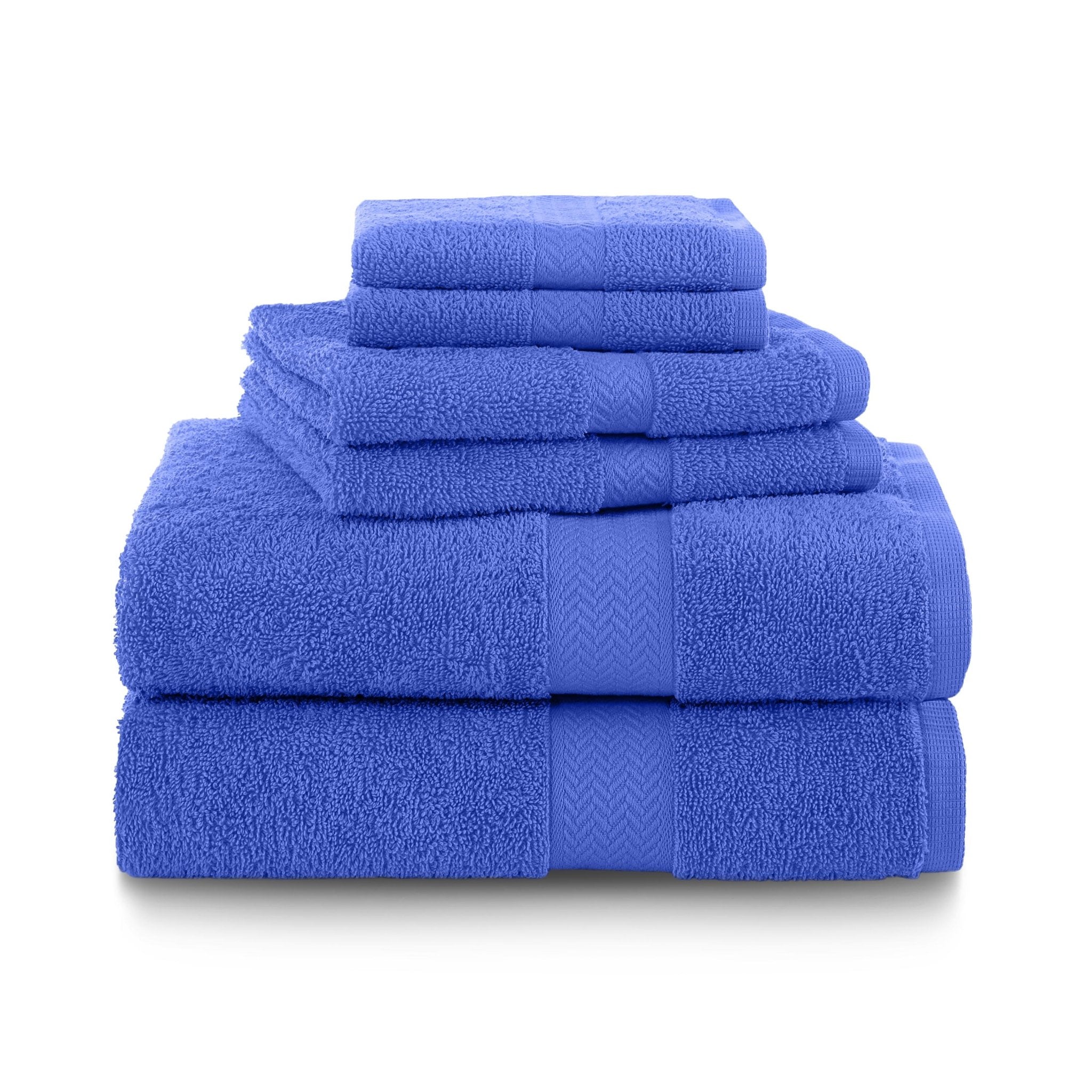 Set of cobalt blue towels stacked on a white background