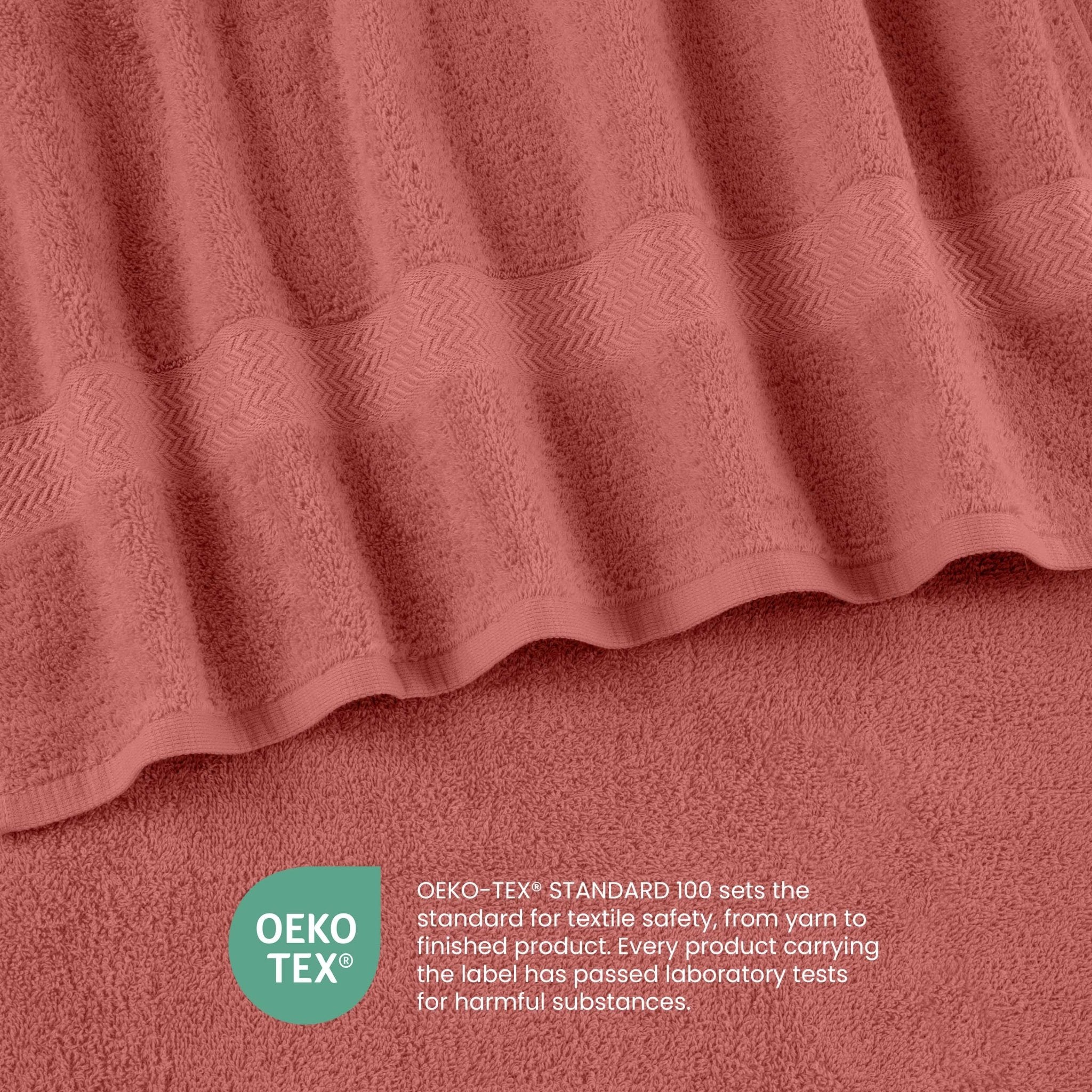 Close-up of coral-colored fabric with a subtle pattern, featuring the OEKO-TEX logo.