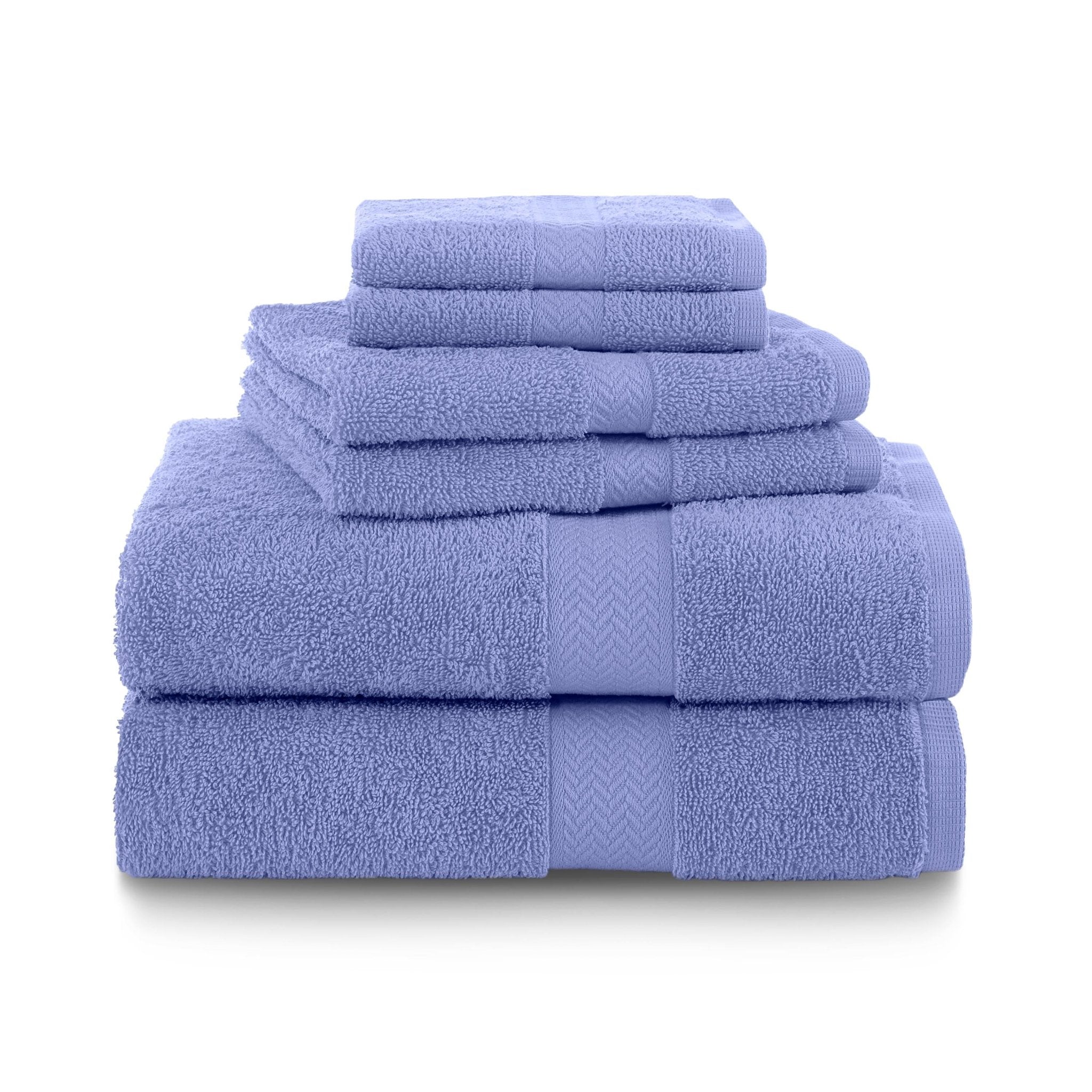Set of lavender towels stacked on a white background