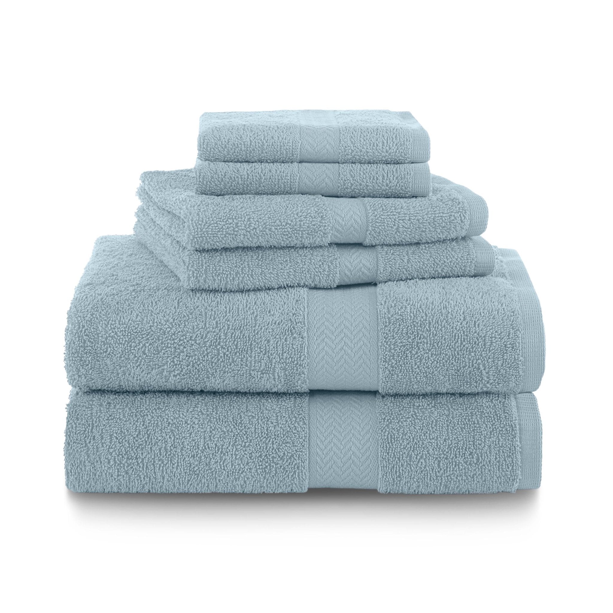 Set of light blue towels stacked on a white background
