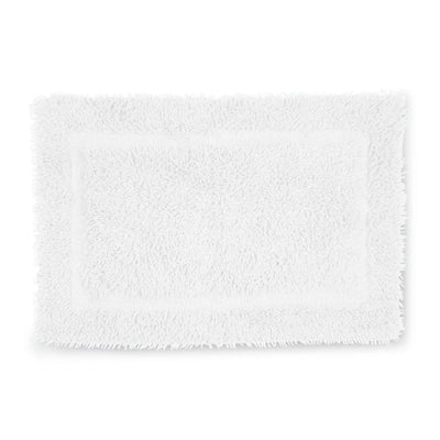 A white rectangular bath rug with a plush, shaggy texture and a raised border, shown against a plain white background.