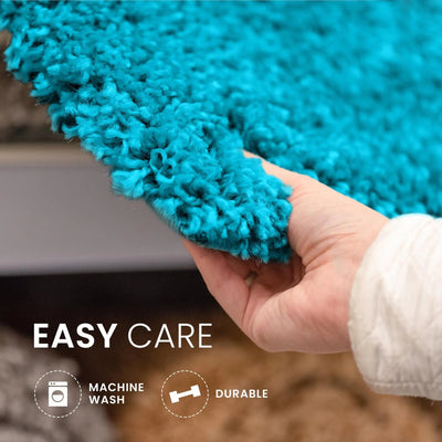 Hand holding a aqua rug with 'Easy Care' text and icons indicating machine wash and durability.