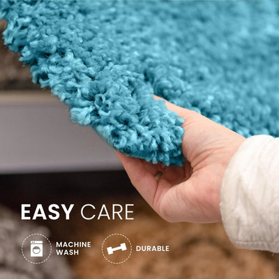 Hand holding a blue textured rug corner with 'Easy Care' text and icons.