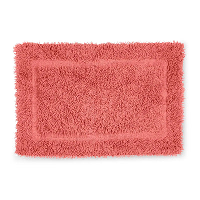 Coral bath rug on a white background