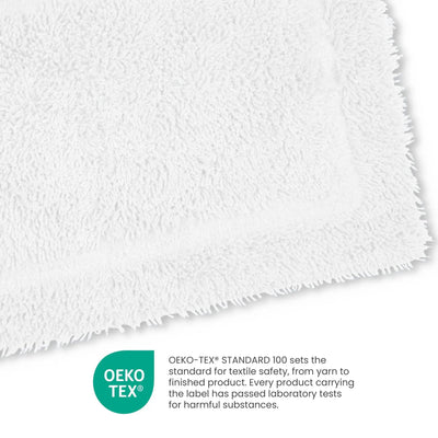 Close-up of white fabric with OEKO-TEX certification label on a white background