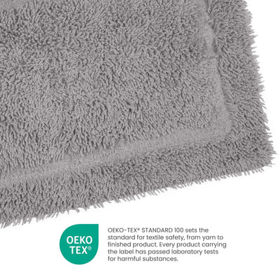 A close-up of a Silver bath mat showing its textured pile and folded corner, with an OEKO-TEX certification badge and text below on a white background.
