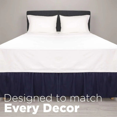 A neatly made bed and a navy bed skirt. Large white text at the bottom reads, 'Designed to match Every Decor.