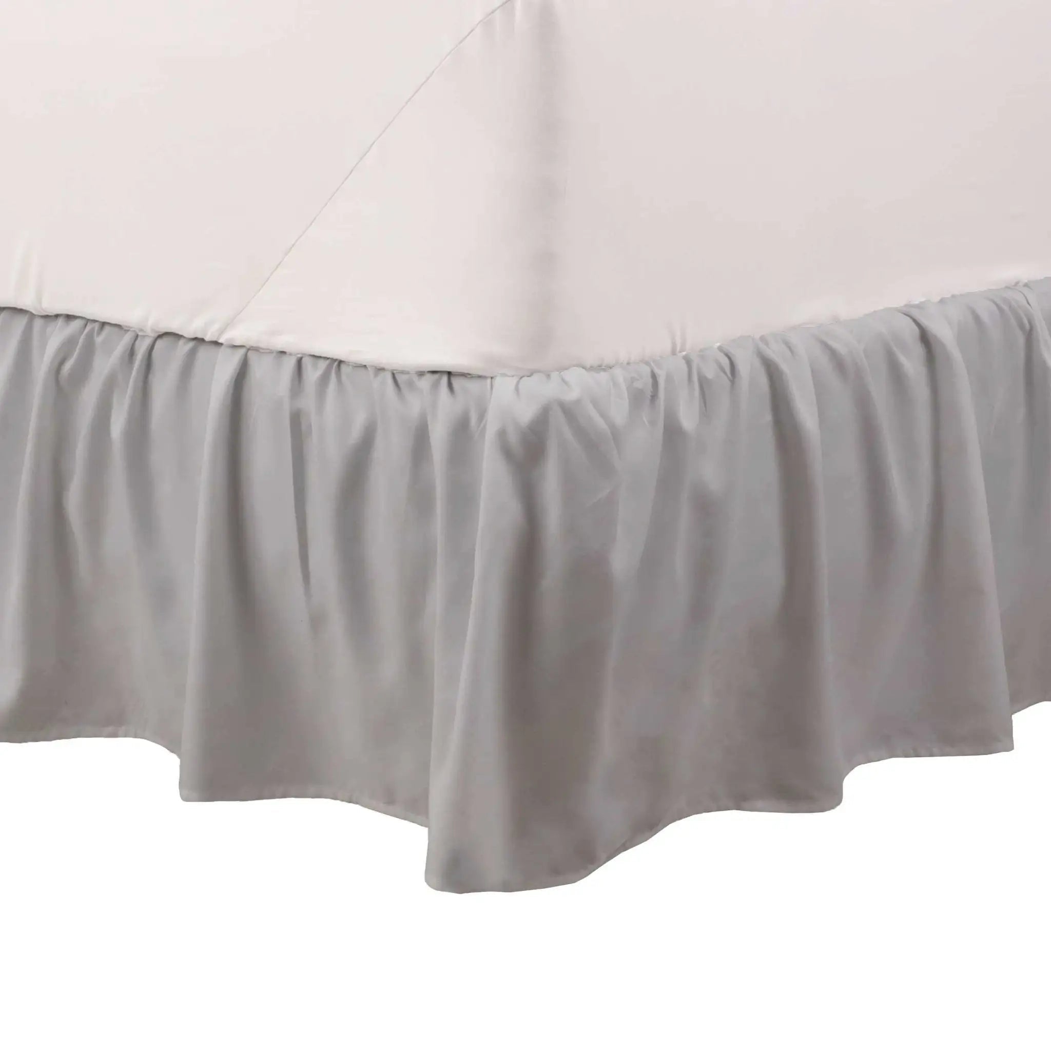 Light grey bed skirt on a white background