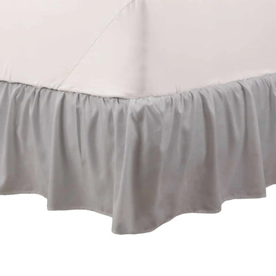 Light grey bed skirt on a white background