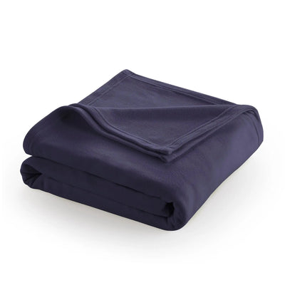 Folded navy blue blanket on a white background