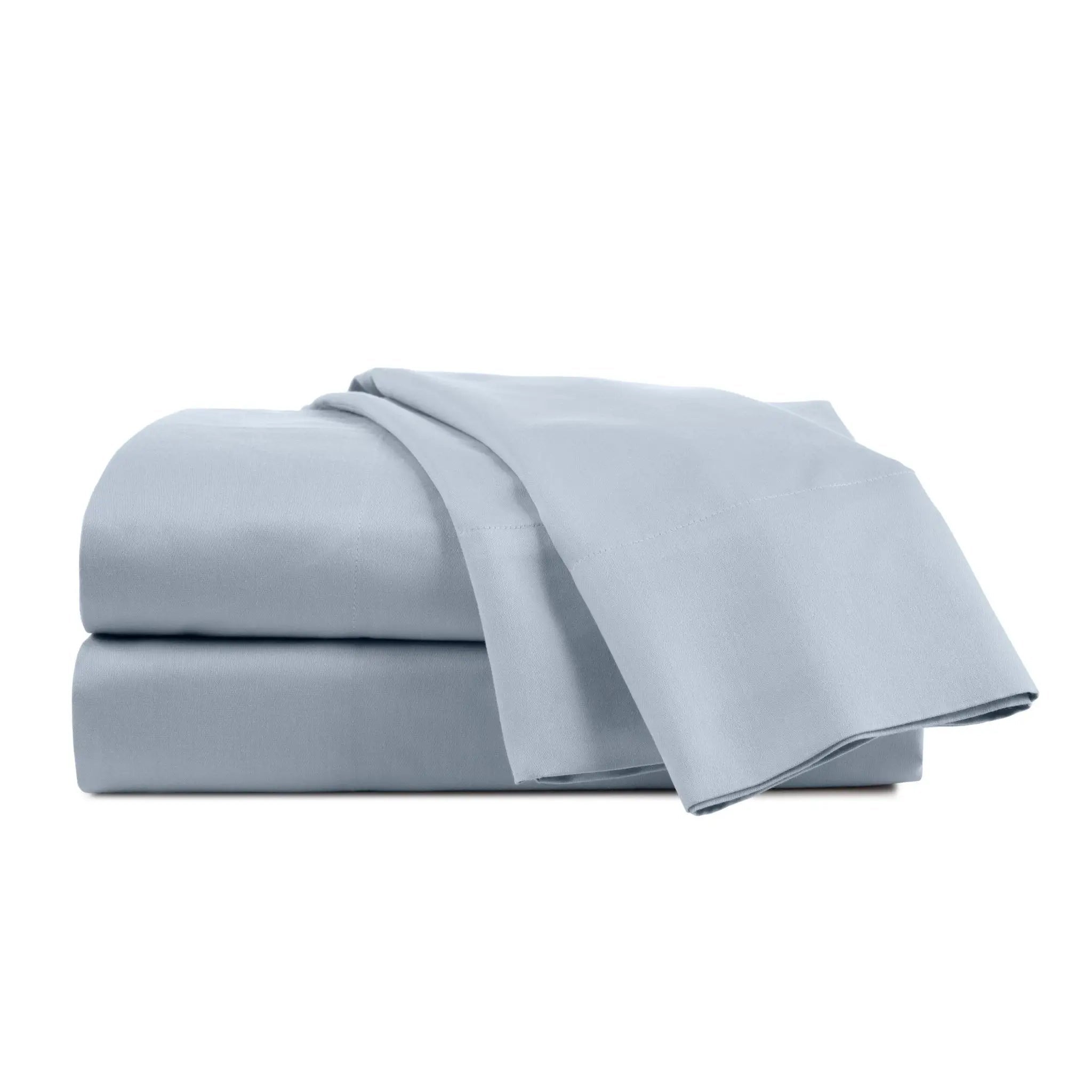 Set of light blue bed sheets on a white background