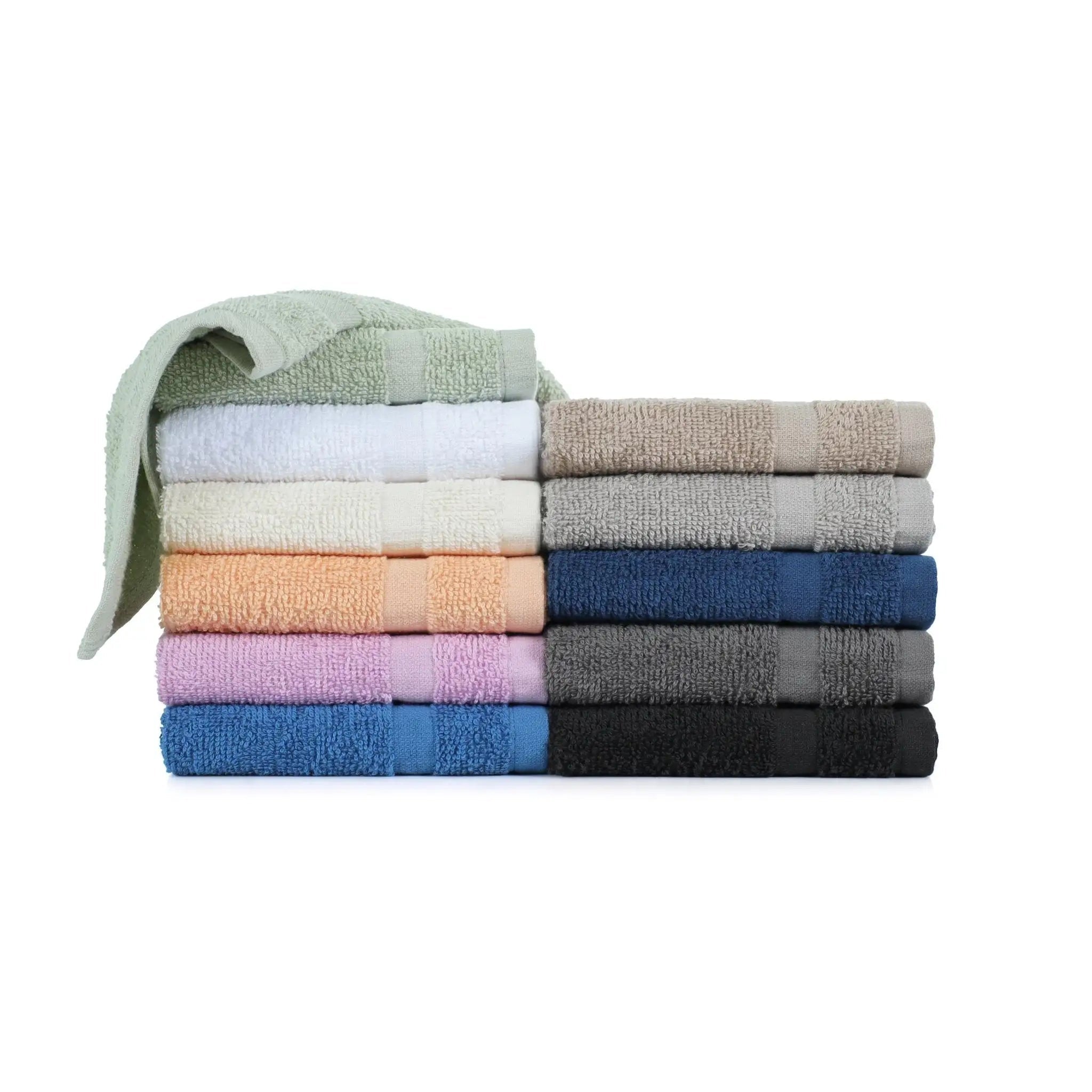 Stack of folded washcloths in various colors on a white background