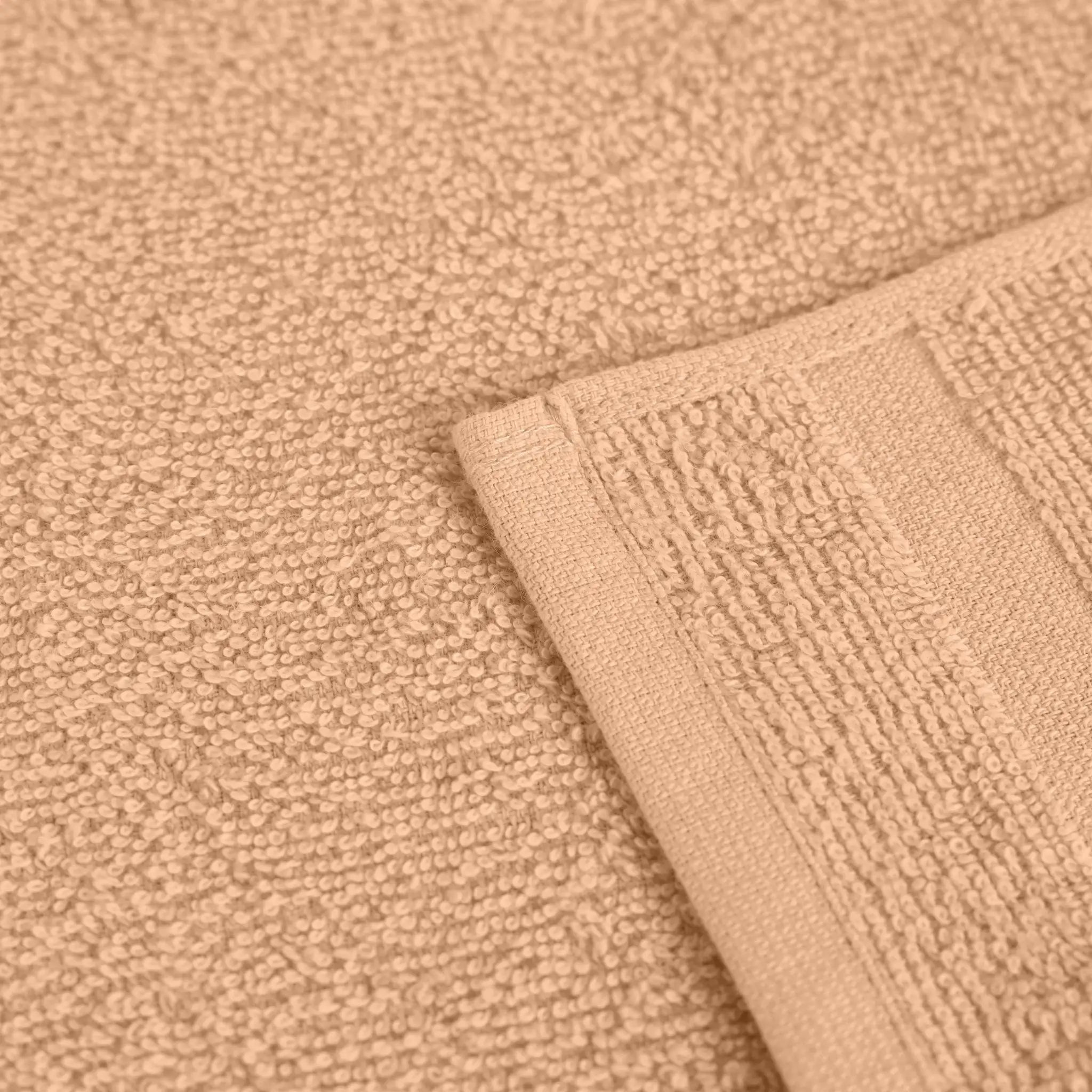 Close-up of textured peach fabric with a folded corner