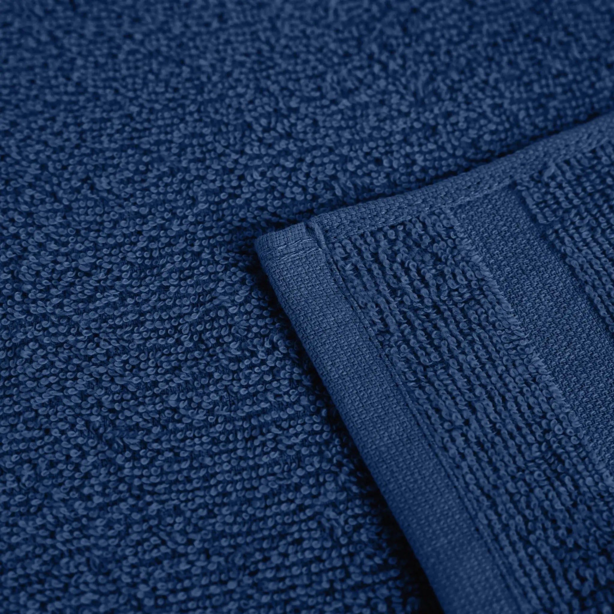 Close-up of a navy textured fabric with a folded corner.