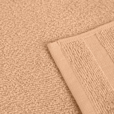 Close-up of a textured peach fabric with a folded edge