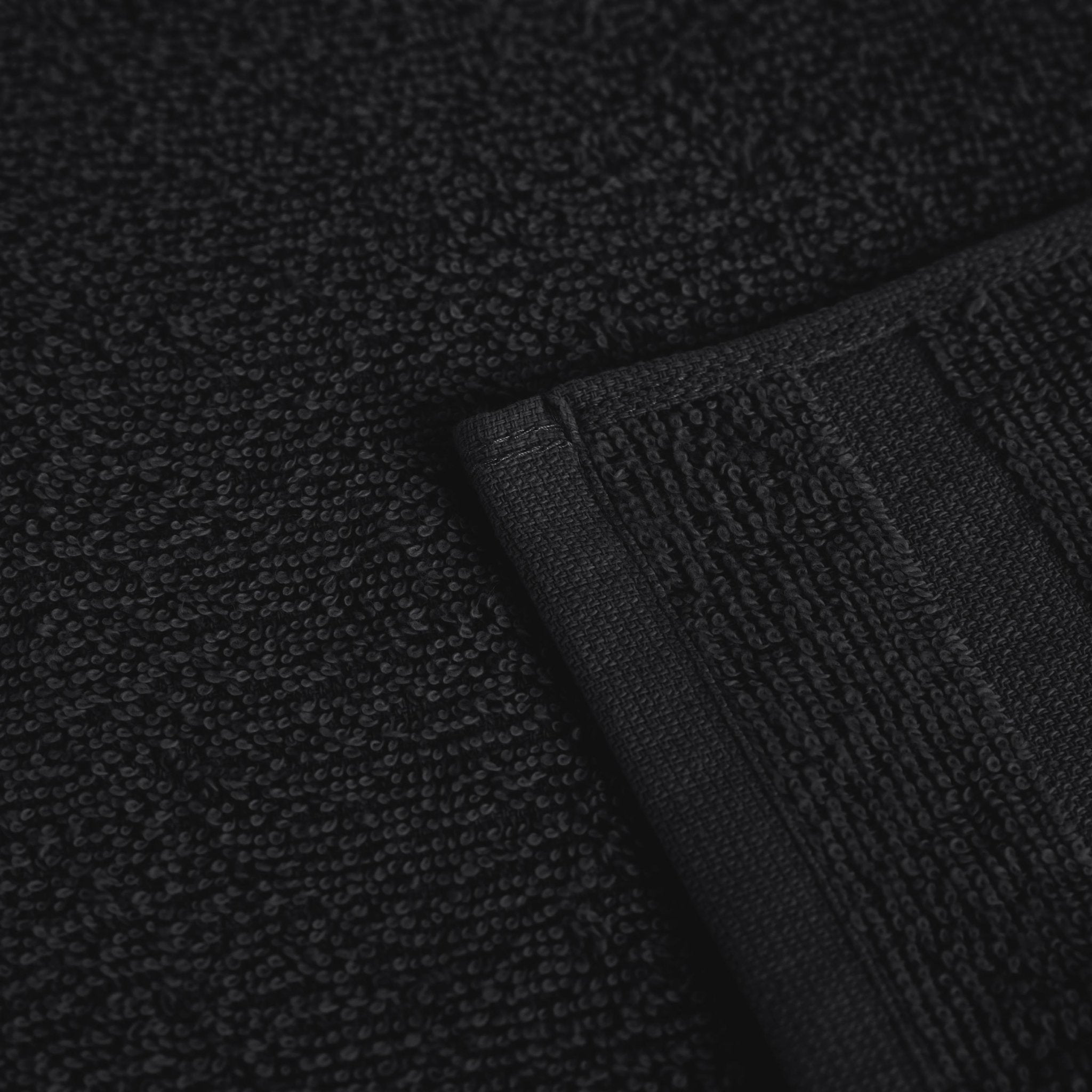 Close-up of a textured black fabric with a folded edge