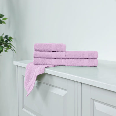Stack of lilac washcloth on a white cabinet.