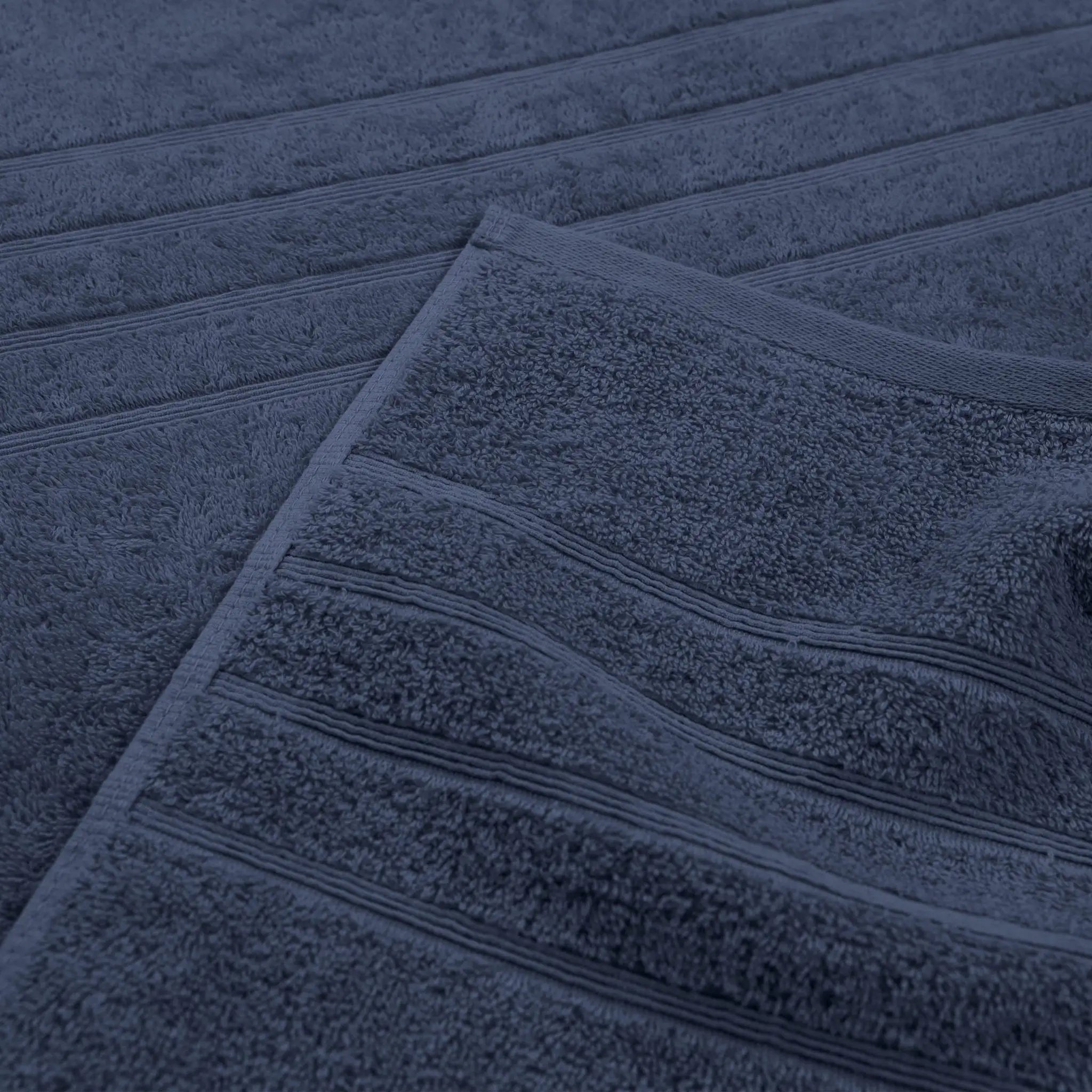 A close-up of an estate blue textured towel with horizontal ribbed detailing.