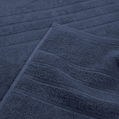 A close-up of an estate blue textured towel with horizontal ribbed detailing.