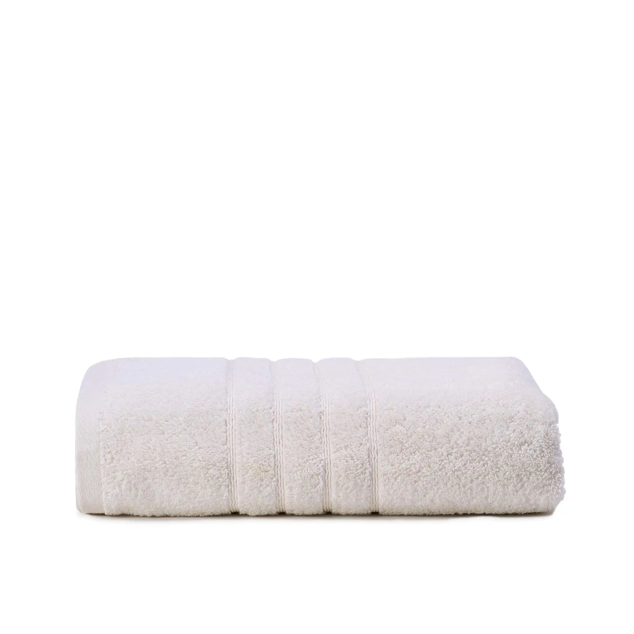 Folded ivory bath towel on a white background