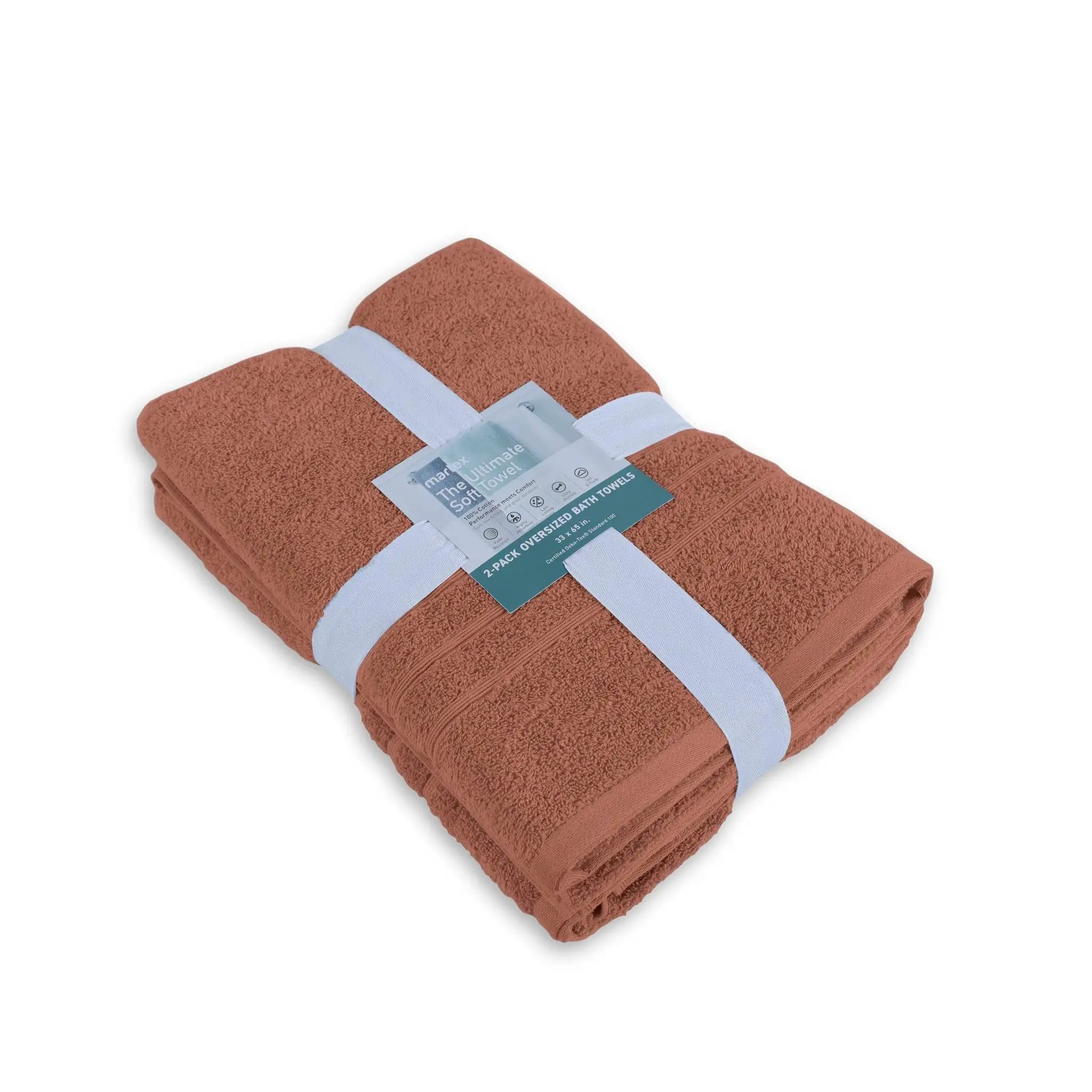 Folded terracotta-colored bath sheet with a label on a white background