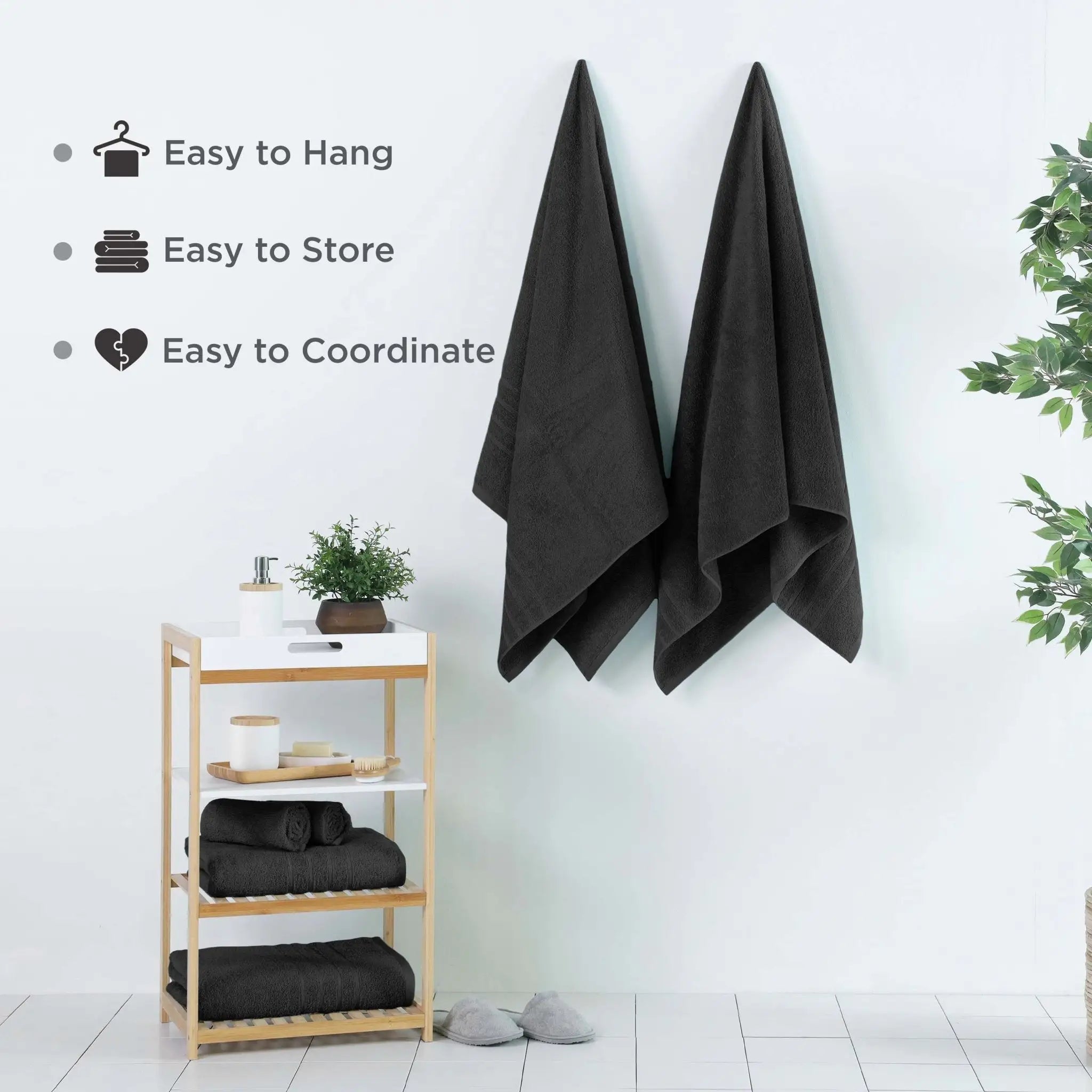 Black bath sheets hanging on a wall with a wooden shelf below, featuring text about towel features.