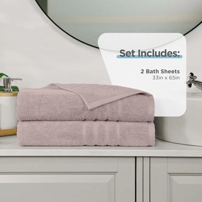 A set of two folded bath sheets in a pink color, stacked on a bathroom counter. A white graphic overlay on the right reads 'Set Includes: 2 Bath Sheets 33in x 65in'.