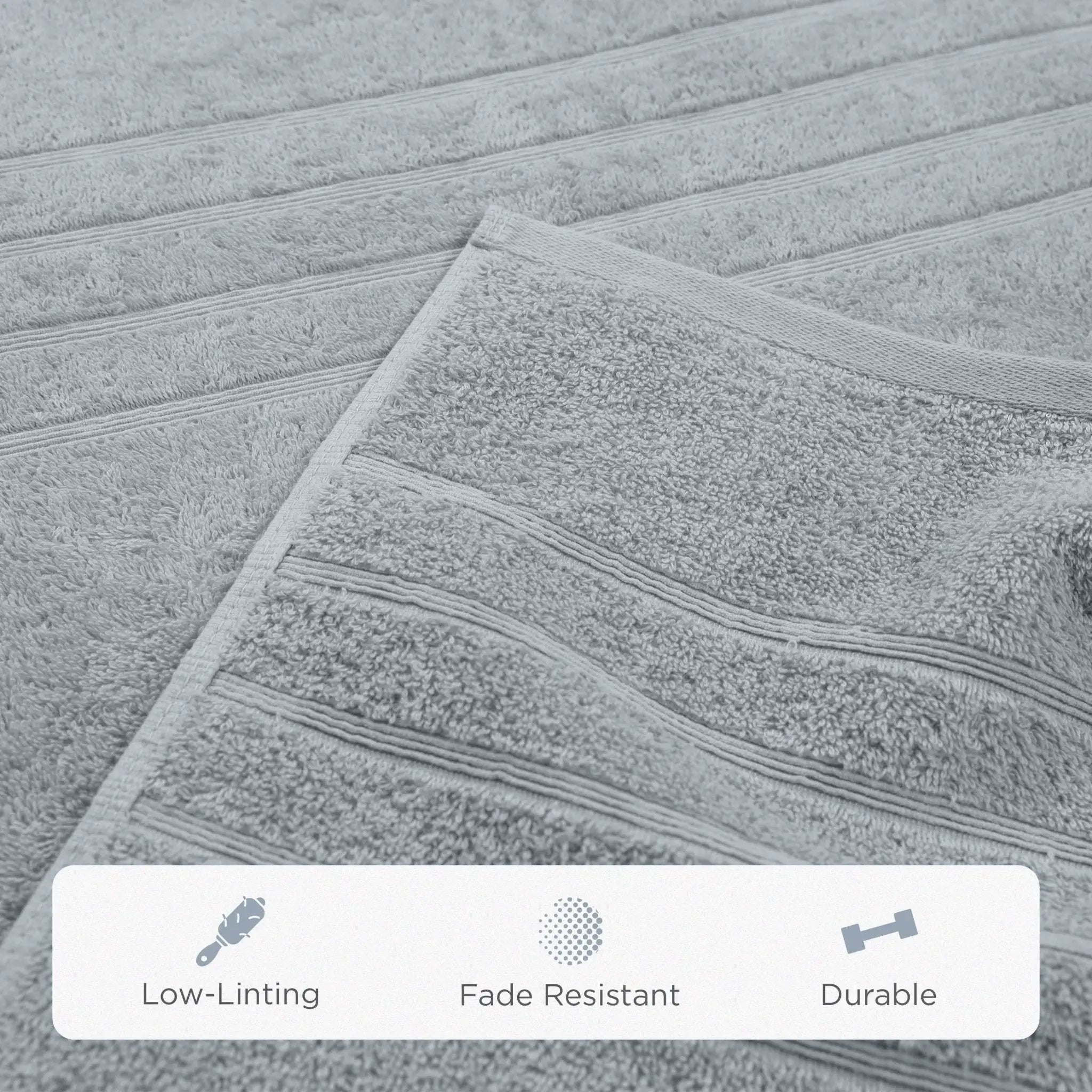 A close-up of a spa blue textured bath sheet with horizontal ribbed stripes, showing a folded corner and a white feature banner at the bottom with text reading Low-Linting, Fade Resistant, and Durable.