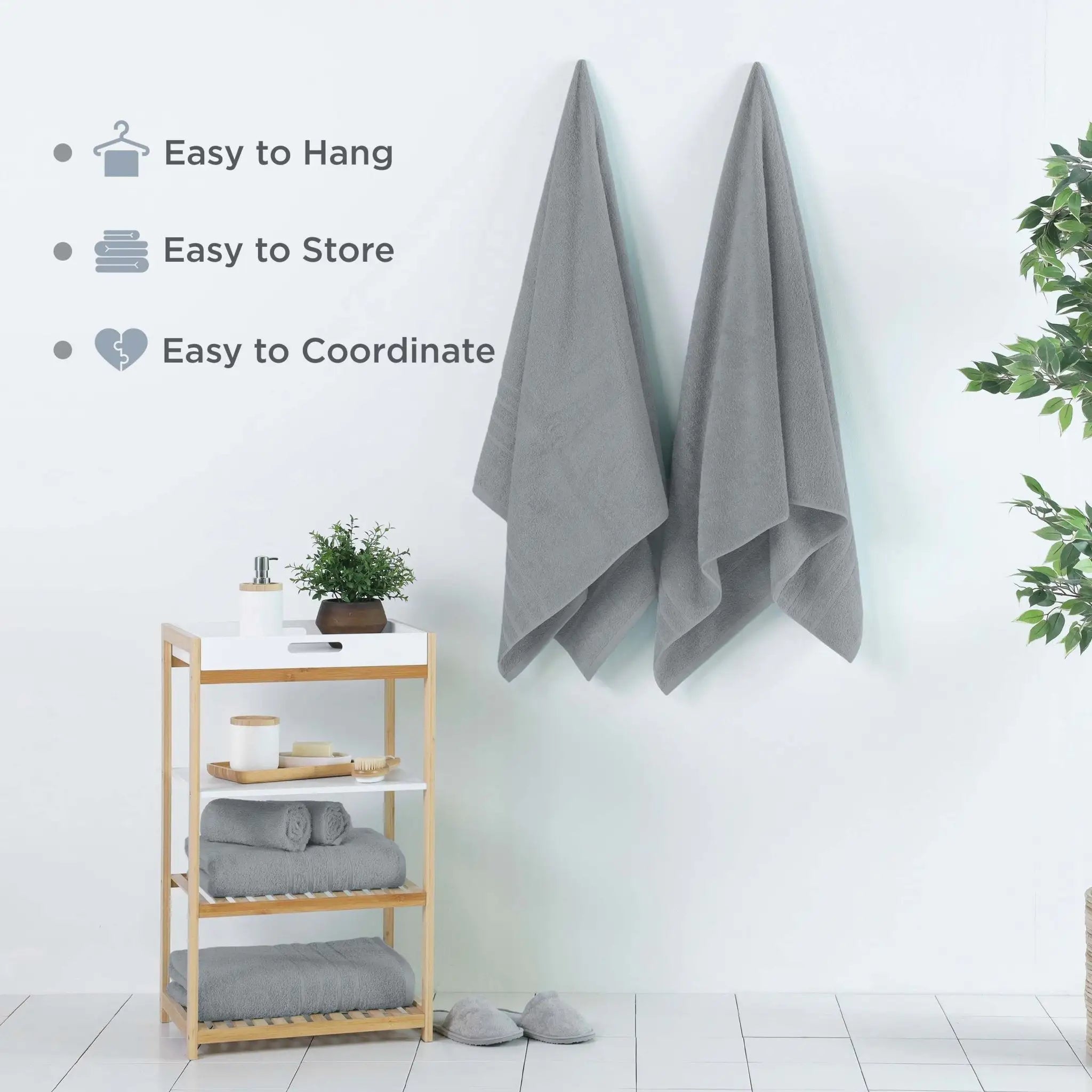 Two spa blue bath sheets hanging on a wall in a bright bathroom setting. Text on the left reads 'Easy to Hang', 'Easy to Store', and 'Easy to Coordinate'.