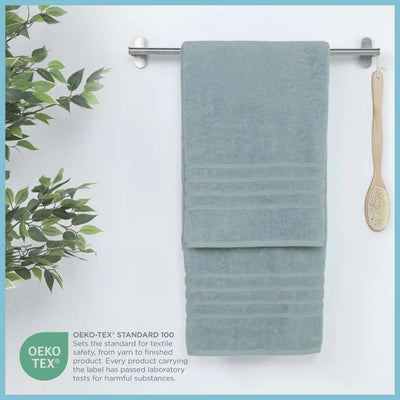 Mineral colored bath sheet hanging on a rack in the background, featuring OEKO-TEX certification.