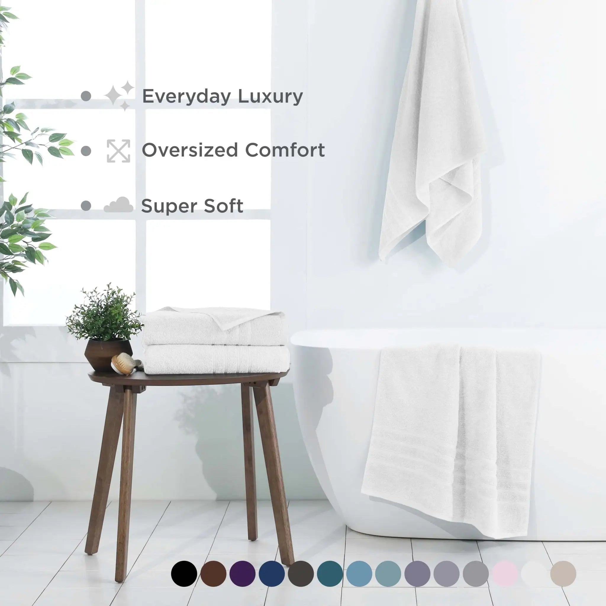 Bathroom setting with white bath sheets, a plant, and a stool, featuring text on comfort and softness.