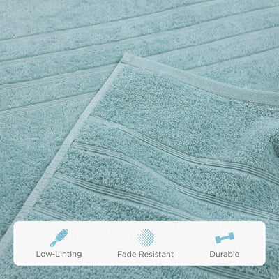 A close-up of a mineral-colored bath sheet with horizontal ribbed stripes, showing its soft terry texture. A white banner at the bottom features icons and the text 'Low-Linting', 'Fade Resistant', and 'Durable'.